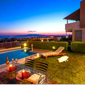 A pool and lawn area with chairs, table and fire pit.